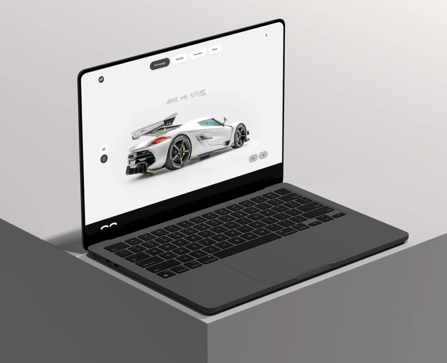 MacBook displaying a hero section of a car brand website
